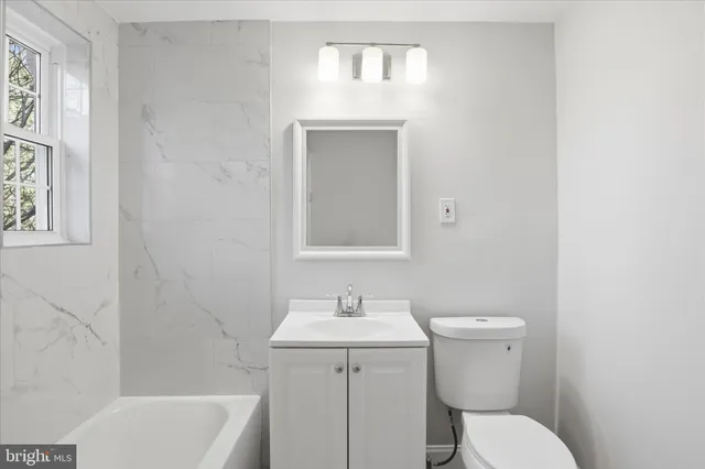 a bathroom with a toilet a sink and bathtub