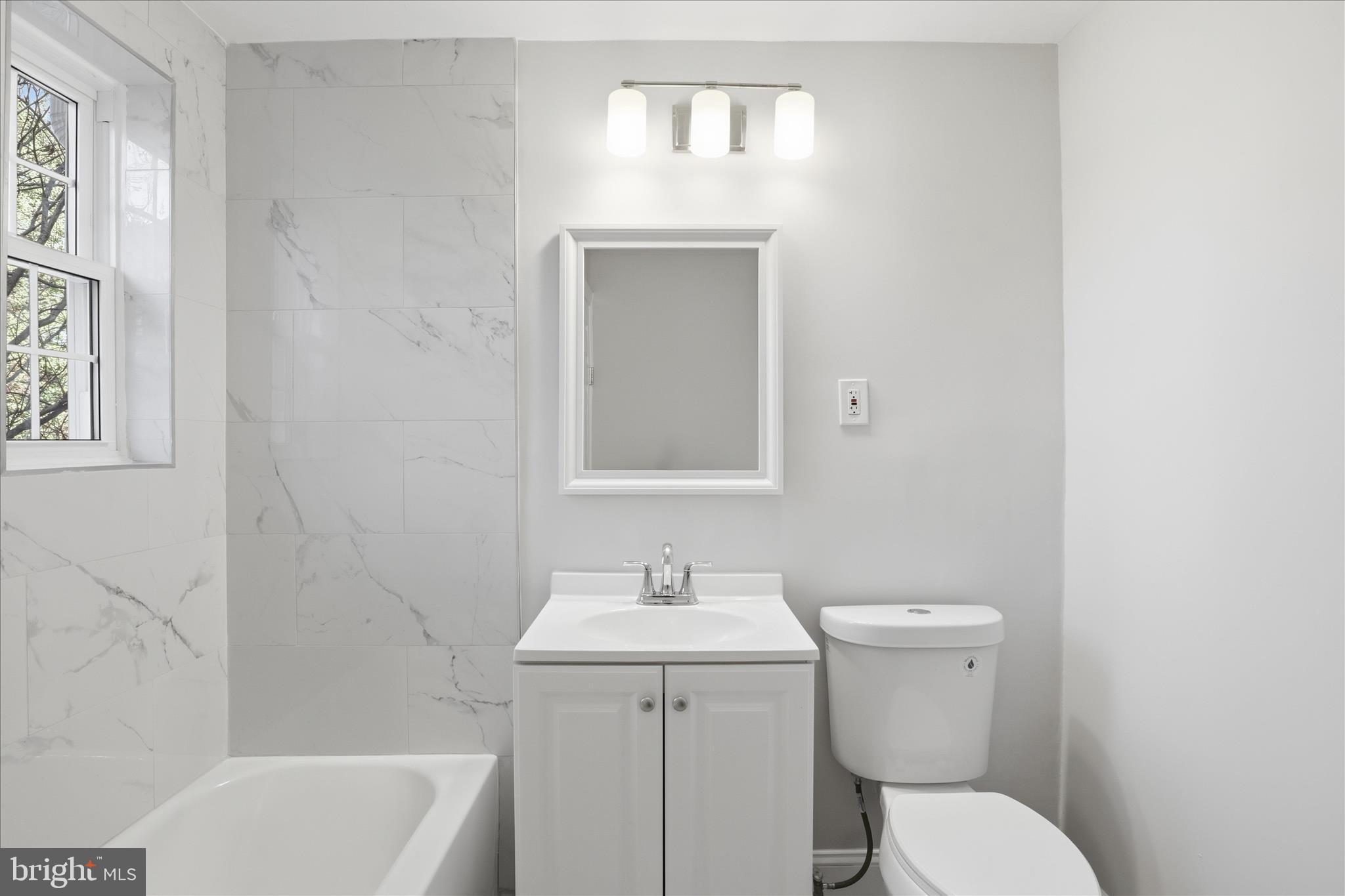1804 West Abingdon Drive, Unit 201 Alexandria, VA 22314 - Photo 18 of 24 a bathroom with a toilet a sink and bathtub