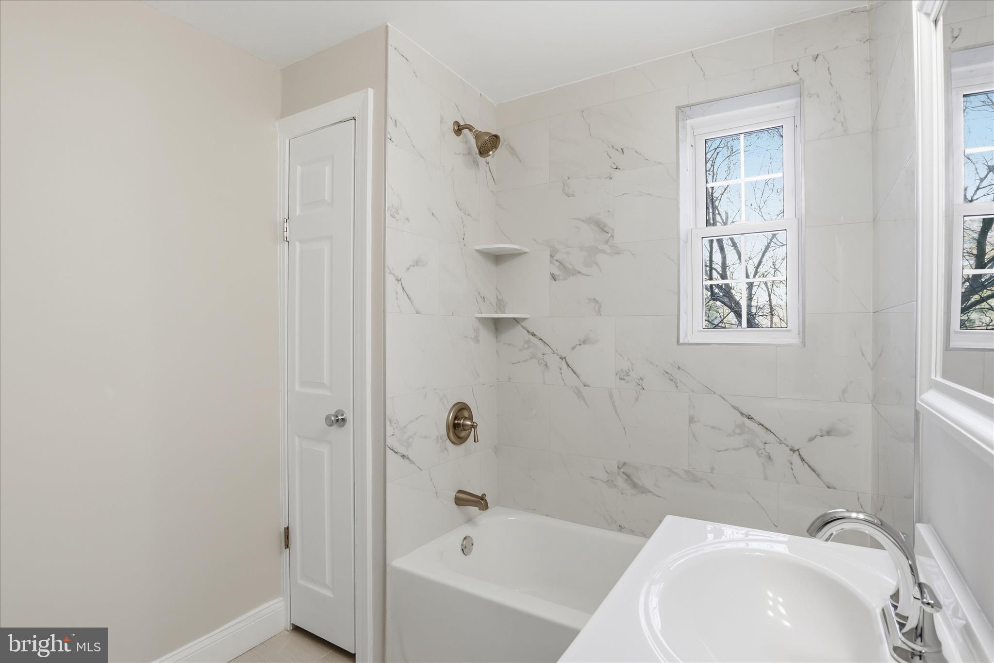 1804 West Abingdon Drive, Unit 201 Alexandria, VA 22314 - Photo 19 of 24 a bathroom with a bathtub and shower