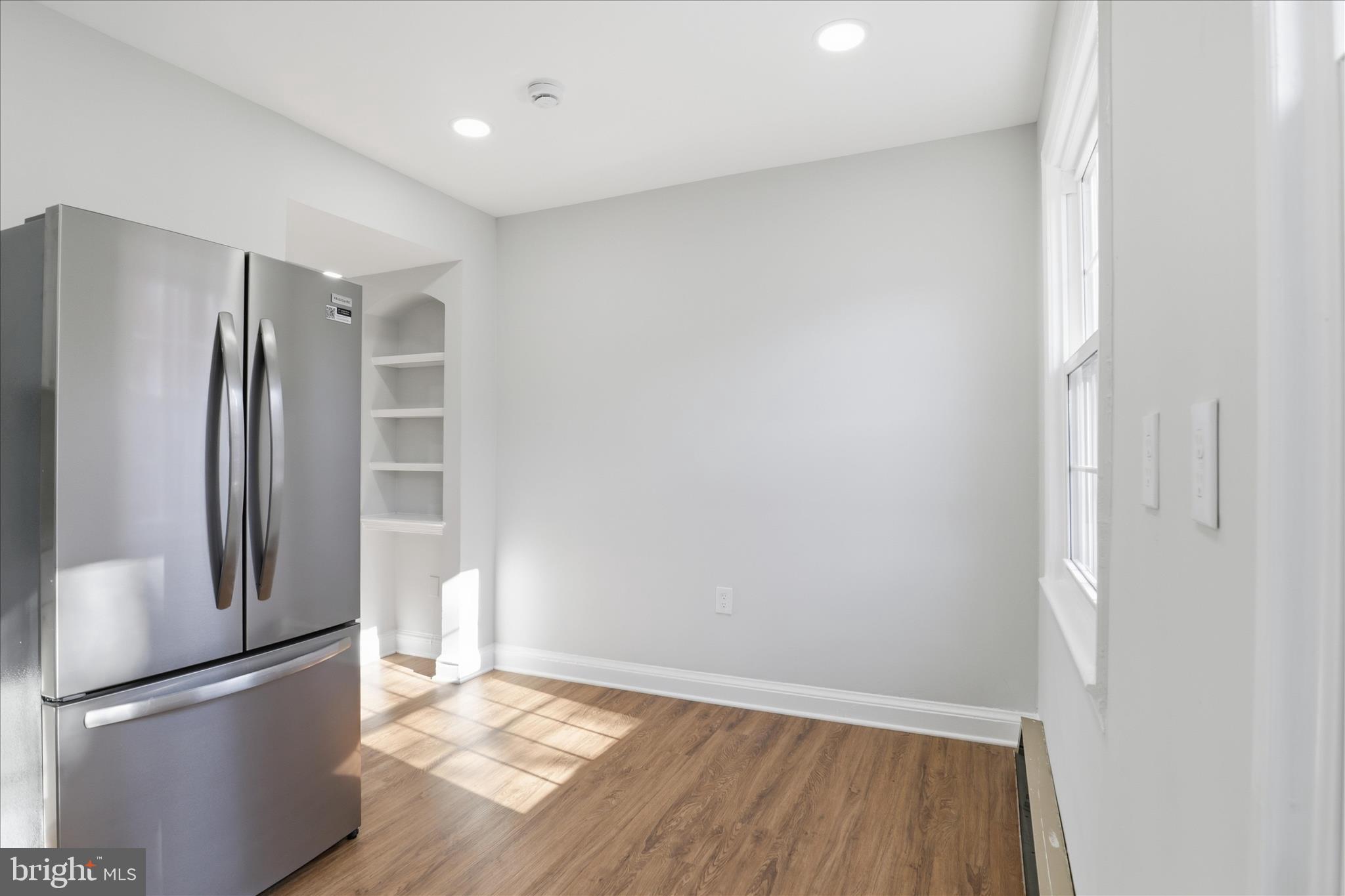1804 West Abingdon Drive, Unit 201 Alexandria, VA 22314 - Photo 10 of 24 a view of empty room with wooden floor and window