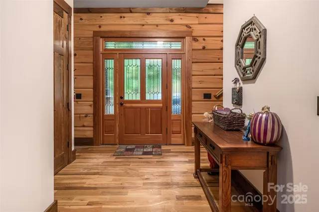 a view of a hallway with entryway wooden floor and front door