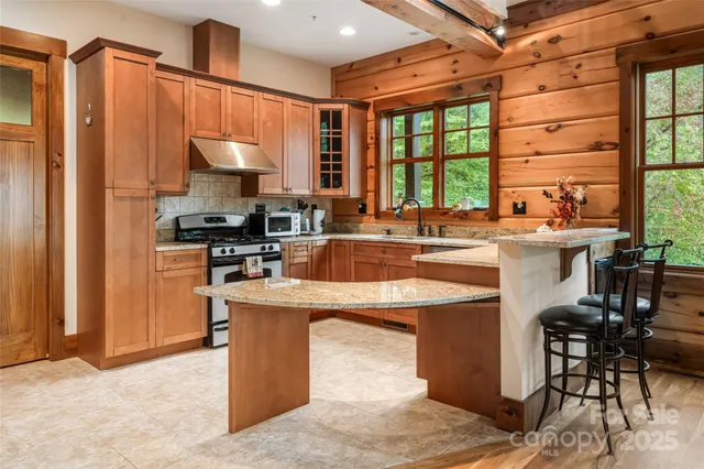 a kitchen with stainless steel appliances a sink stove and a refrigerator