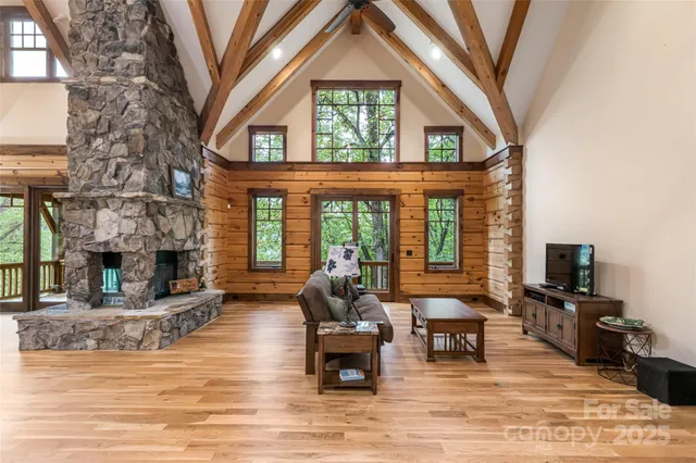 a living room with fireplace furniture and a large window