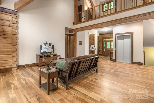a view of a balcony with chairs and wooden floor