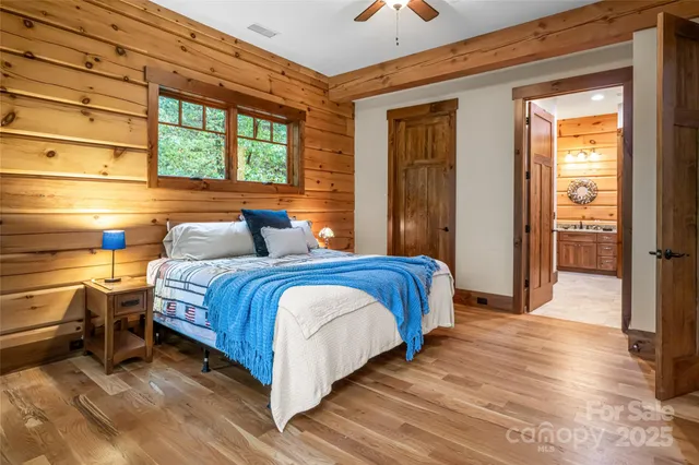 a bedroom with a bed and wooden floor