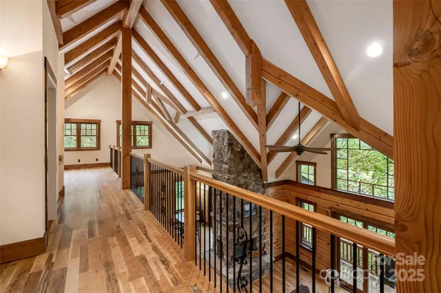 a view of staircase with lots of frames on wall and a large window