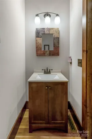 a bathroom with a sink vanity and a mirror