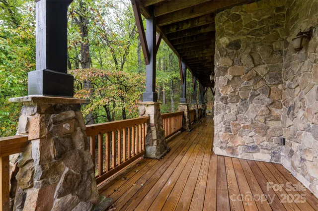 a view of balcony with wooden floor and fence