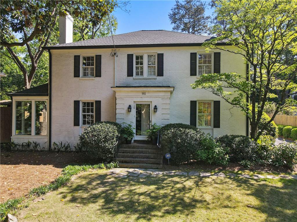 a front view of a house with garden