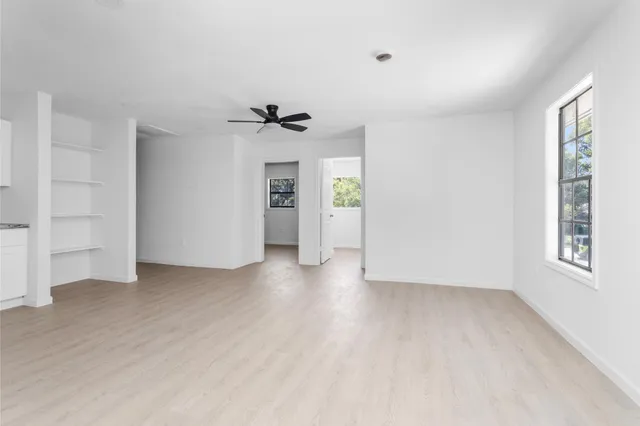 an empty room with windows and closet