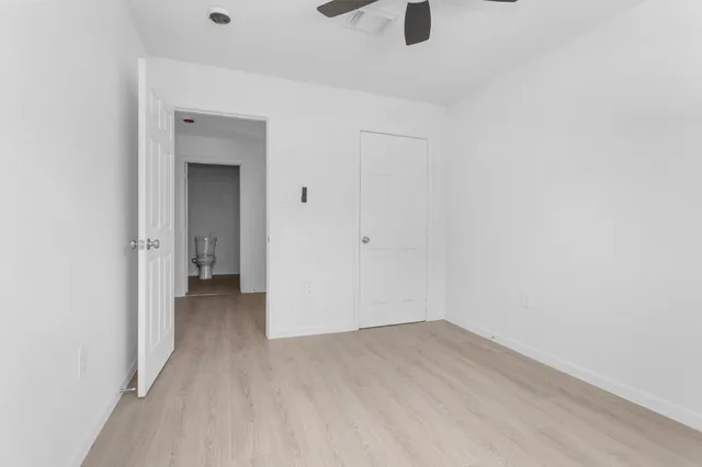 a view of a room with wooden floor