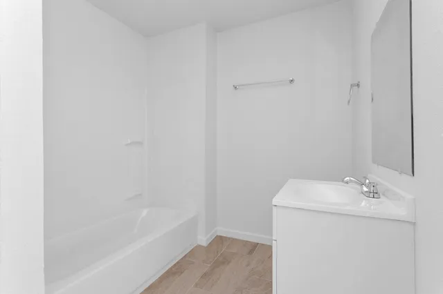 a bathroom with a sink a mirror and a bathtub