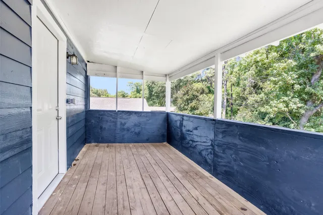 a view of balcony with wooden floor