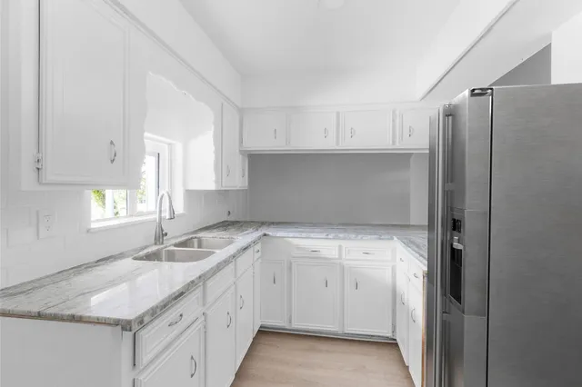 a kitchen with a sink stove and cabinets