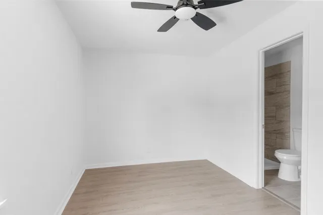 a view of a balcony with wooden floor and fence