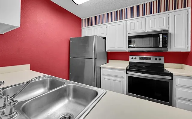 a kitchen with a refrigerator stove and microwave