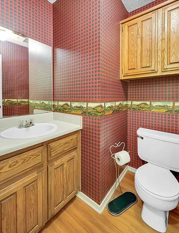 a bathroom with a sink a toilet and mirror