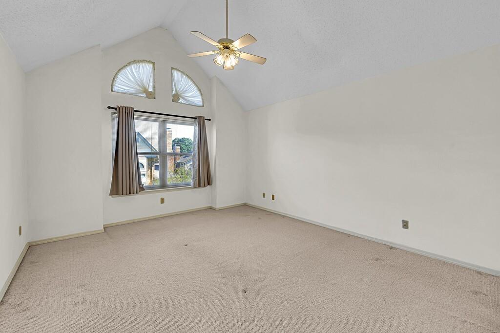 112 Pleasant Grove Lane Waco, TX 76712 - Photo 19 of 34 an empty room with chandelier fan and wooden floor