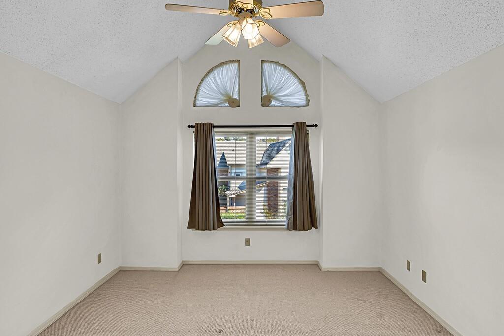 112 Pleasant Grove Lane Waco, TX 76712 - Photo 20 of 34 an empty room with chandelier fan and wooden floor
