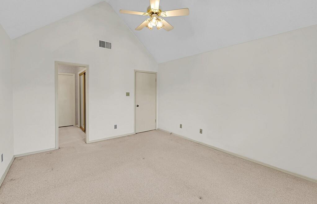 112 Pleasant Grove Lane Waco, TX 76712 - Photo 21 of 34 an empty room with a chandelier fan and windows