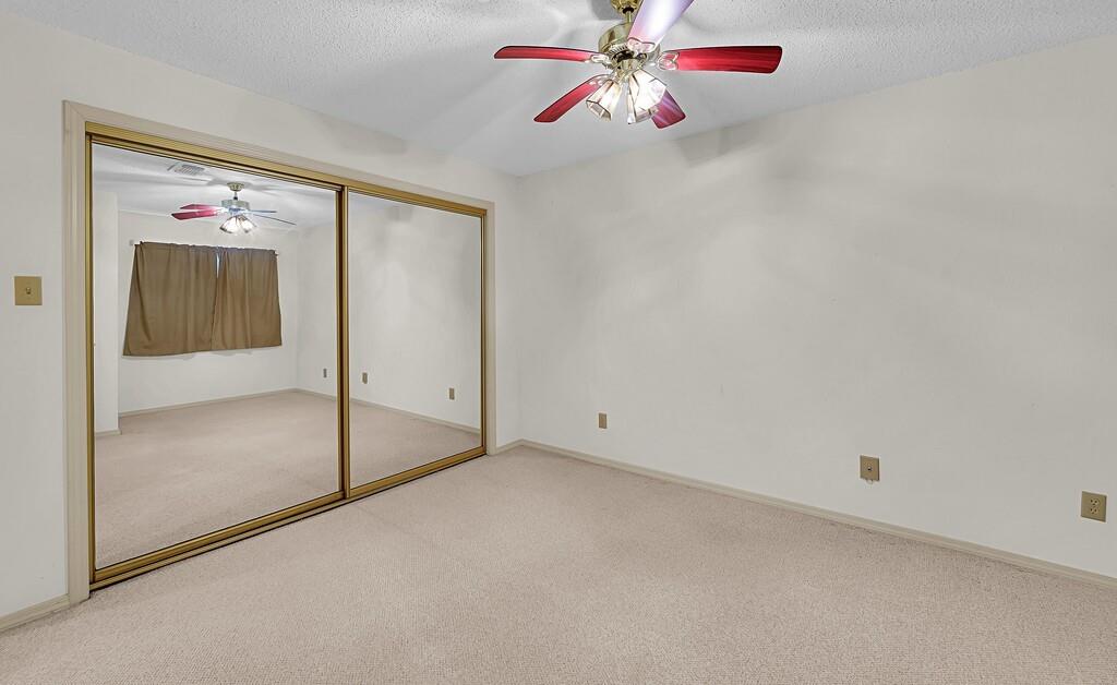 112 Pleasant Grove Lane Waco, TX 76712 - Photo 24 of 34 an empty room with a chandelier fan and windows