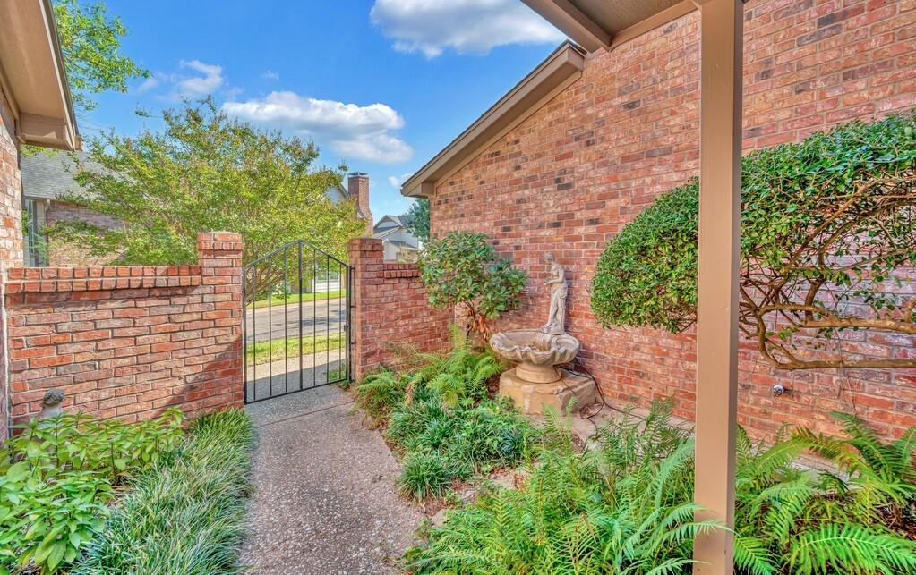 112 Pleasant Grove Lane Waco, TX 76712 - Photo 5 of 34 a view of a backyard with brick wall and potted plants