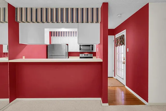 a view of kitchen with furniture and a refrigerator