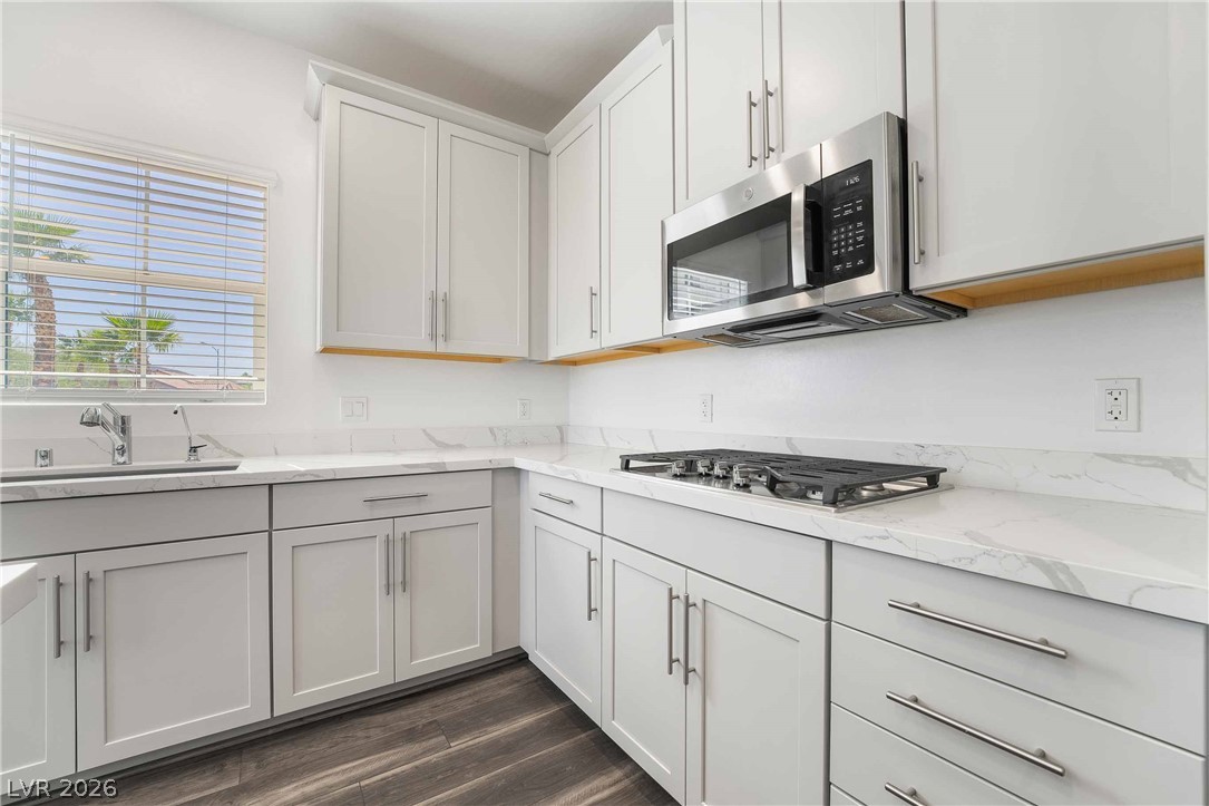 2555 Hampton Road, Unit 10202 Henderson, NV 89052 - Photo 14 of 35 Sleek stone countertops and classic cabinetry complement the modern built-in appliances and wood flooring.