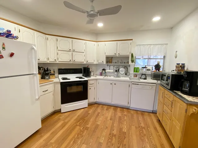 a kitchen with a white cabinets and white appliances
