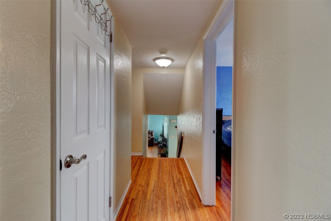 923 Peninsula Drive Ormond Beach, FL 32176 - Photo 14 of 33 a view of a hallway with wooden floor and a bathroom