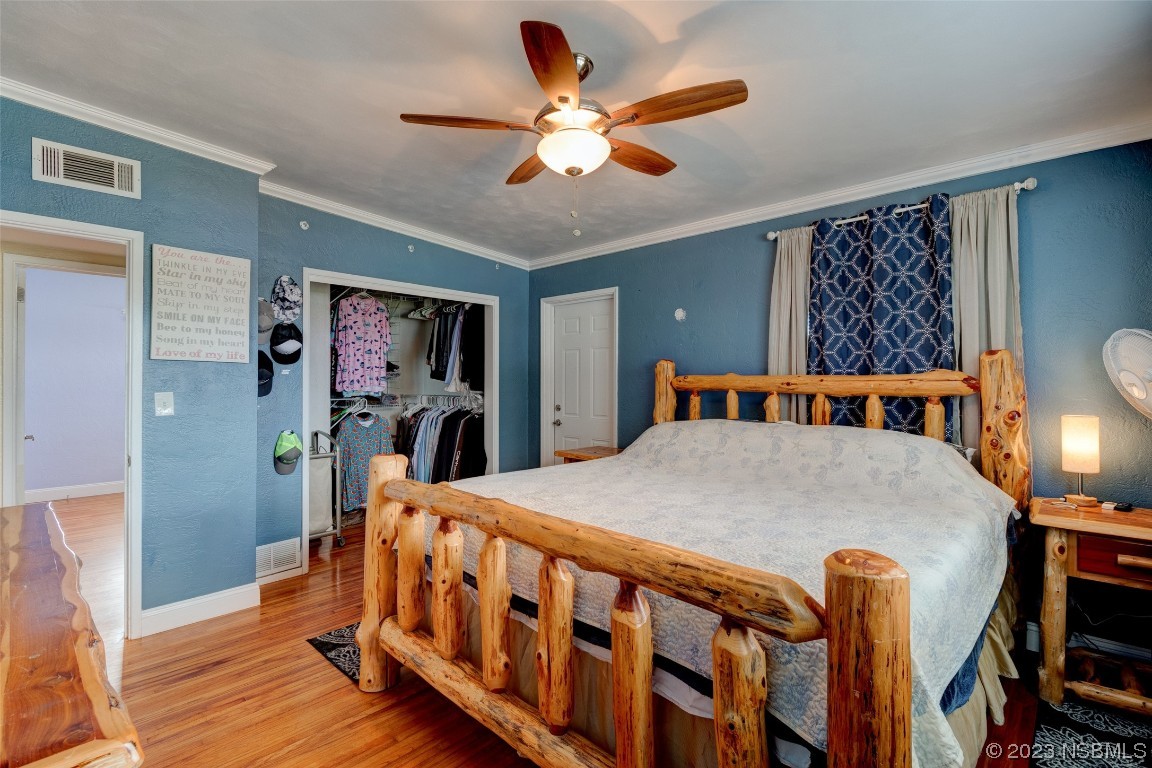 923 Peninsula Drive Ormond Beach, FL 32176 - Photo 21 of 33 a bed room with furniture and a chandelier