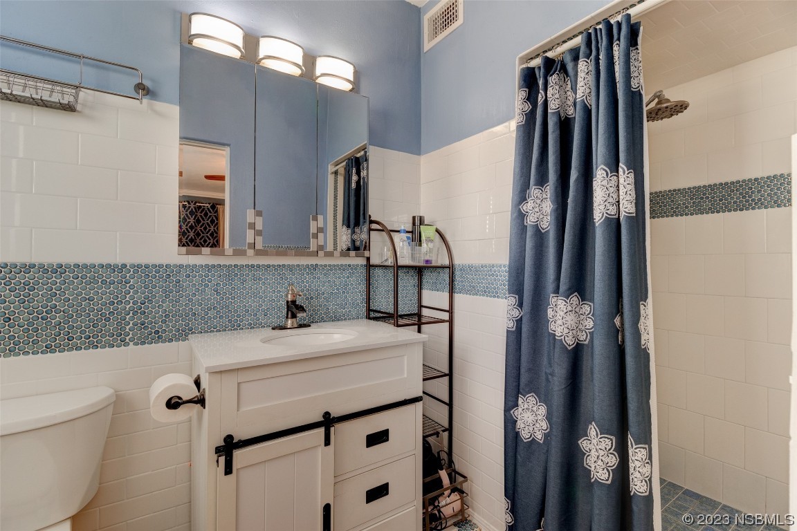923 Peninsula Drive Ormond Beach, FL 32176 - Photo 22 of 33 a bathroom with a sink toilet and shower