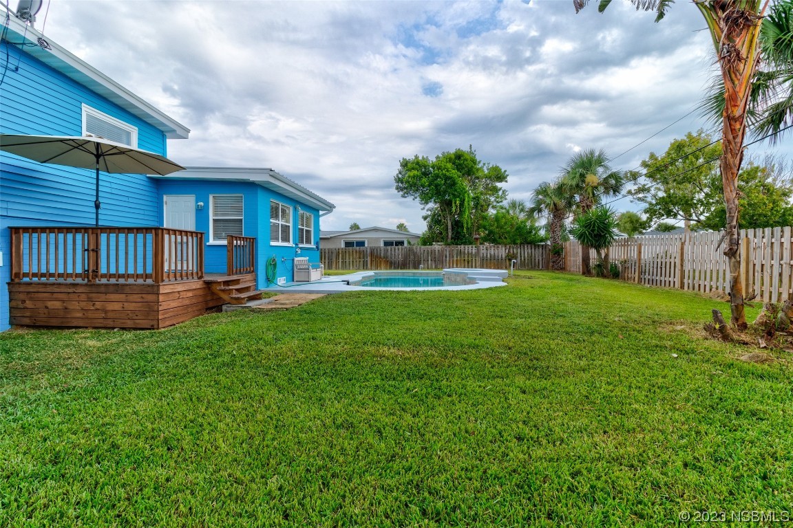 923 Peninsula Drive Ormond Beach, FL 32176 - Photo 26 of 33 a view of backyard with table and chairs and wooden fence