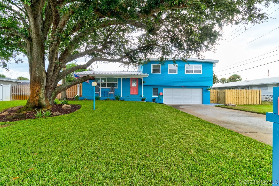 923 Peninsula Drive Ormond Beach, FL 32176 - Photo 3 of 33 a front view of a house with garden