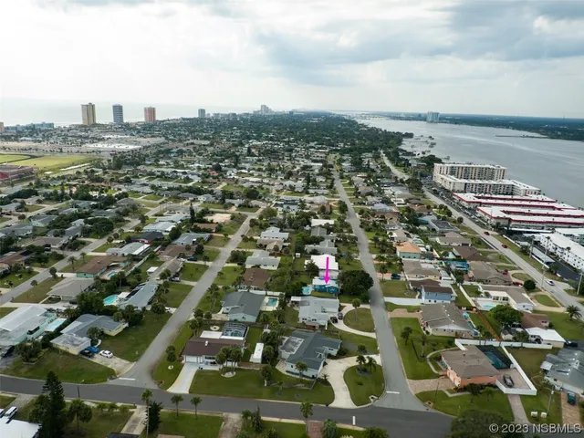 an aerial view of residential houses with city view