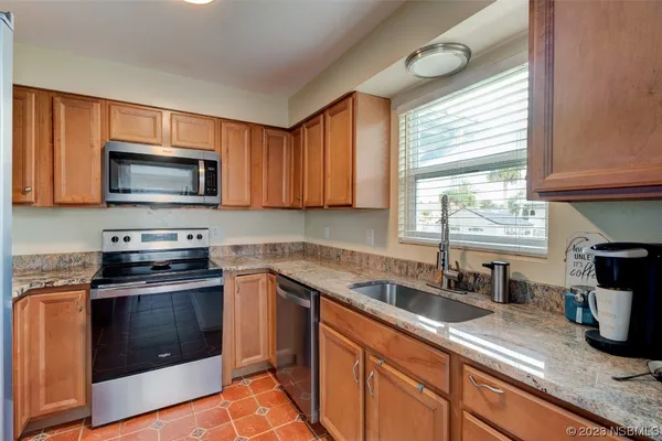 a kitchen with a sink stove and microwave