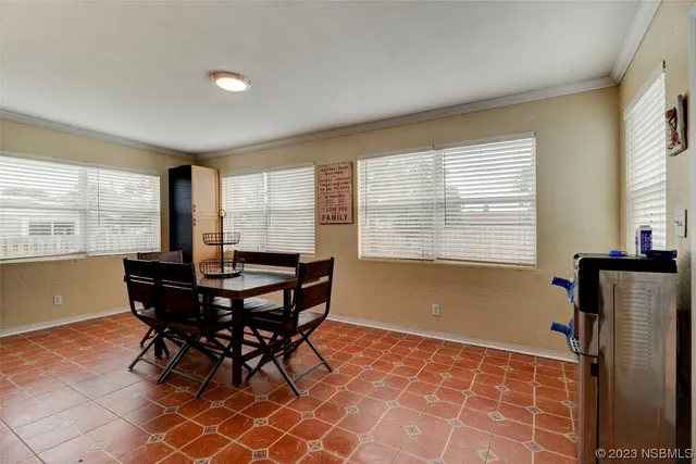 a view of a dining room with furniture and a window