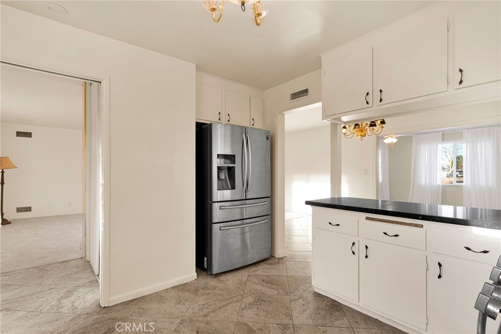 15177 Mendota Road North Apple Valley, CA 92307 - Photo 11 of 50 a kitchen with cabinets and stainless steel appliances