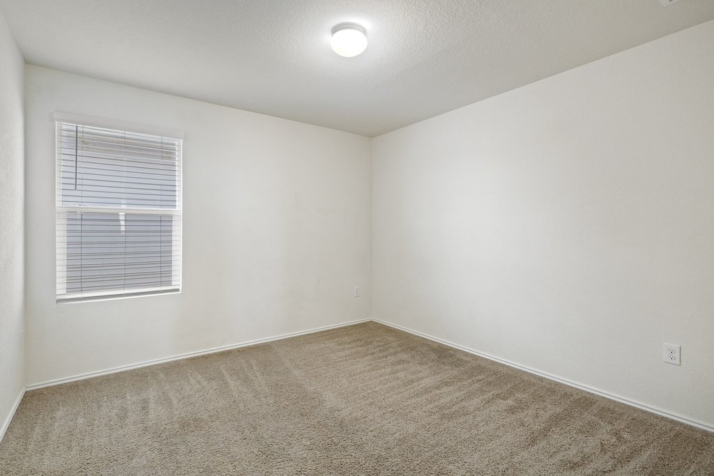 15011 Tuff Rd Manor Manor, TX 78653 - Photo 28 of 37 Secondary bedroom with carpet, neutral walls, and a window for natural light, perfect for a guest room, nursery, or home office.