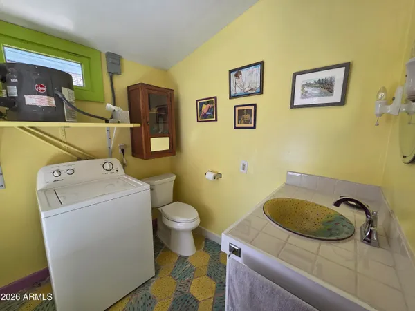 a bathroom with a sink and a washer dryer