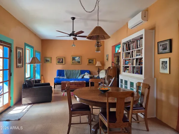 a view of a dining room with furniture and a window