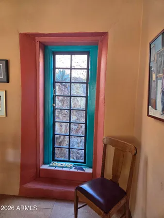 a view of an front door with a chair and a window