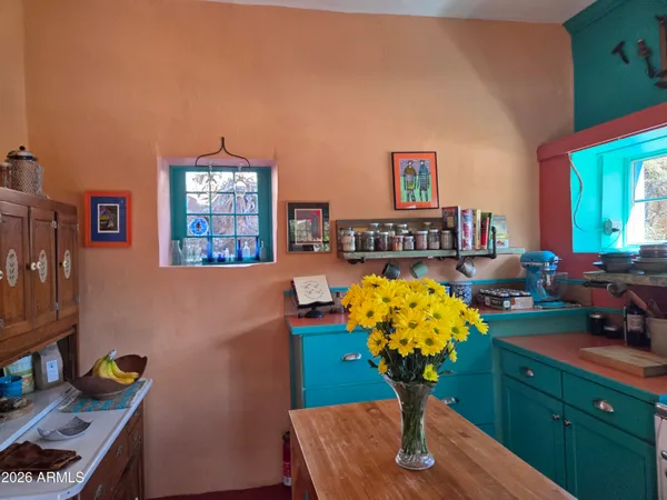 a vase of flowers sitting on a table with a bookshelf
