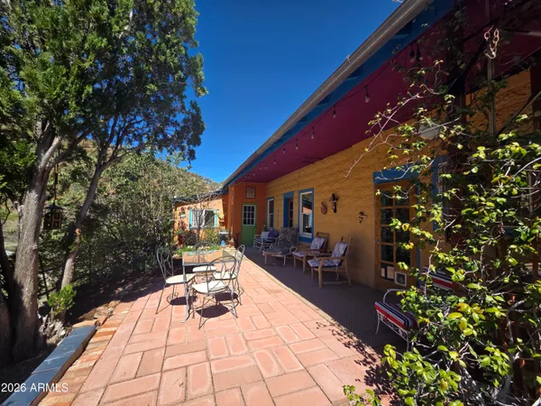 a view of a patio with table and chairs and potted plants