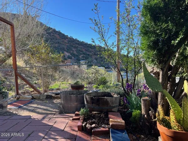 a view of backyard with plants and outdoor seating