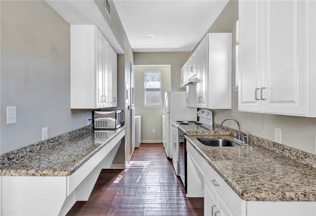 209 Davis Street, Unit MULTIPLE S AVAILABLE Bryan, TX 77801 - Photo 3 of 11 a kitchen with a stove sink and cabinets