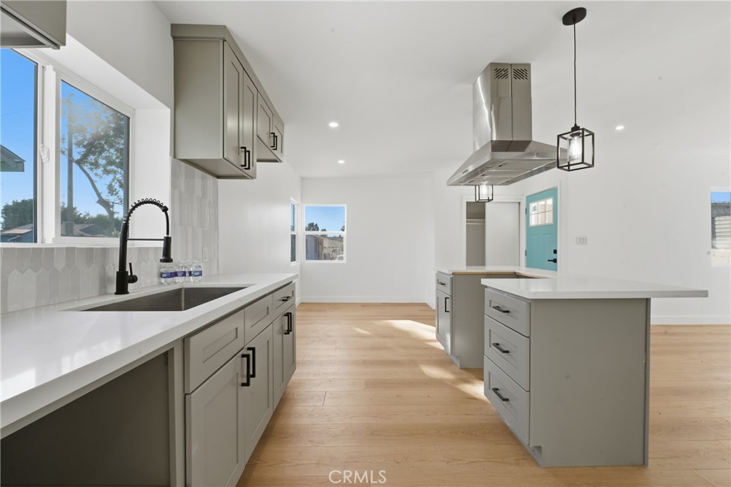 1736 North McDivitt Avenue Compton, CA 90221 - Photo 12 of 30 a kitchen with stainless steel appliances a sink stove and cabinets