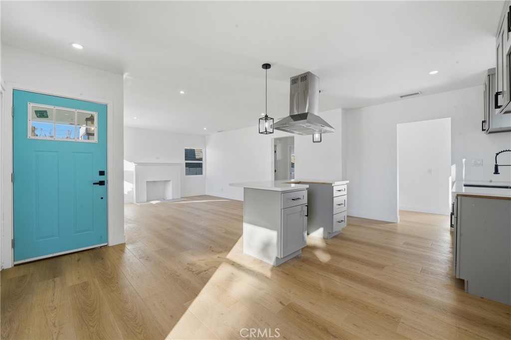 1736 North McDivitt Avenue Compton, CA 90221 - Photo 15 of 30 a view of a kitchen with furniture and wooden floor