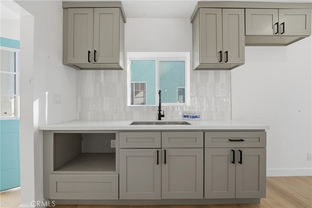 1736 North McDivitt Avenue Compton, CA 90221 - Photo 17 of 30 a kitchen with white cabinets and a sink
