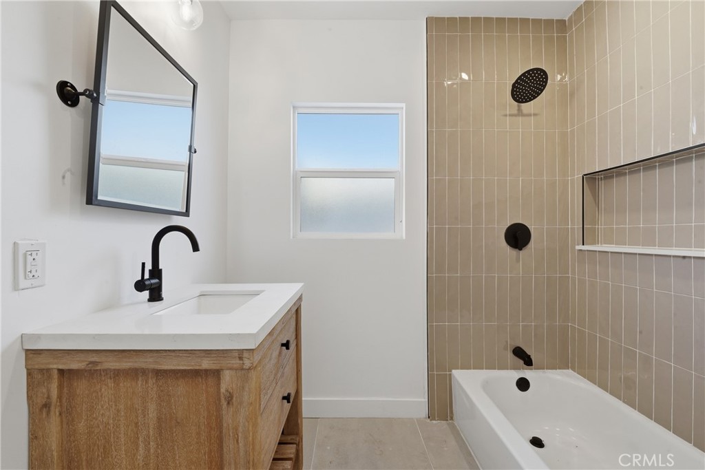 1736 North McDivitt Avenue Compton, CA 90221 - Photo 18 of 30 a bathroom with a sink a vanity and a tub